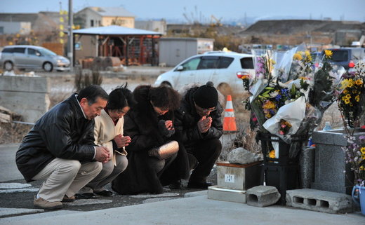 Japanese praying for tsunami victims