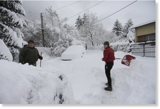 Sofia residents dig their cars out from the heavy snow in Sofia, Bulgaria