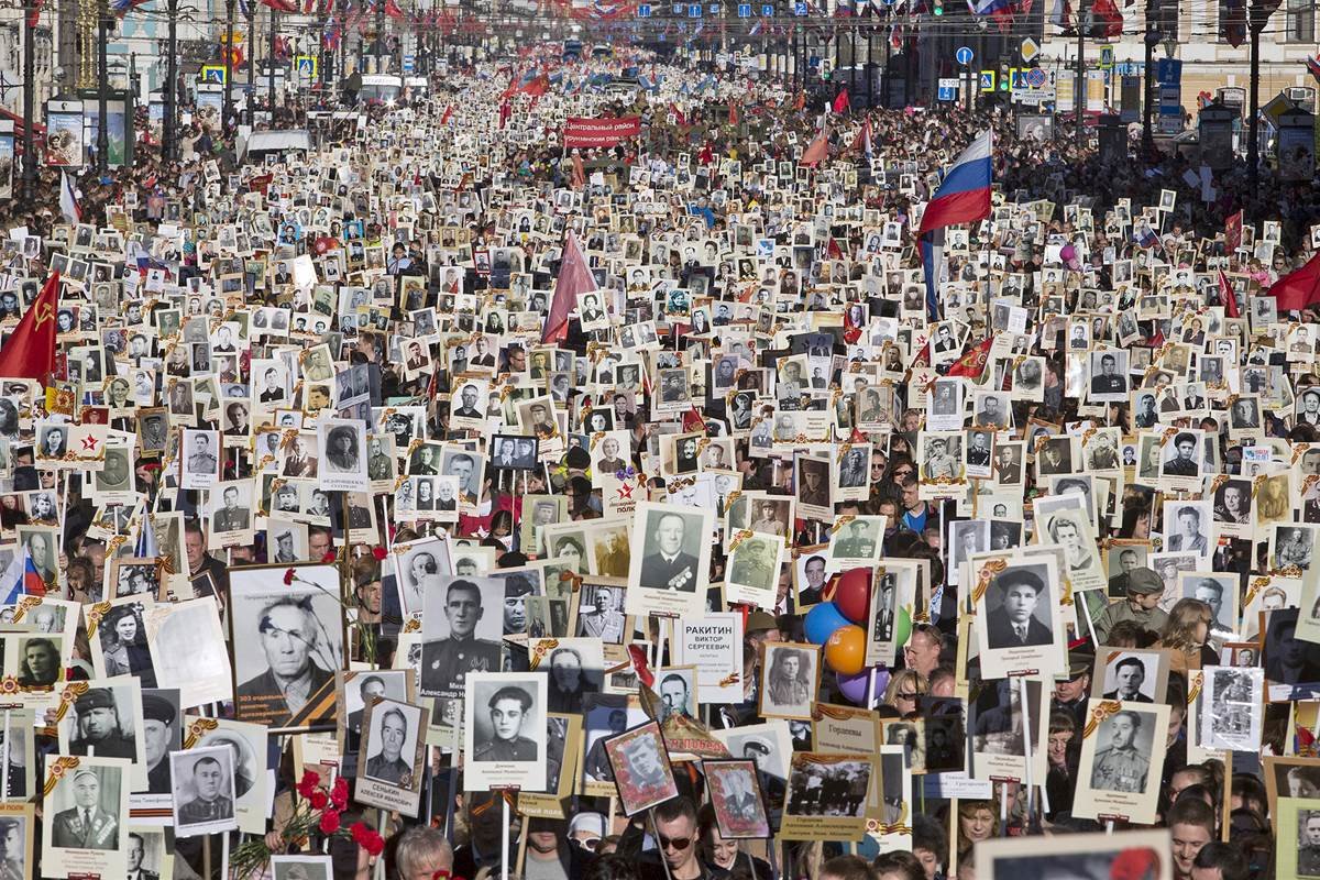 Local residents carry portraits of their ancestors and participants in World War Two as they celebrate the 70th anniversary of the defeat of the Nazis in St. Petersburg