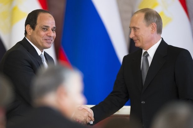 Russian President Putin (R) shakes hands with his Egyptian counterpart al-Sisi