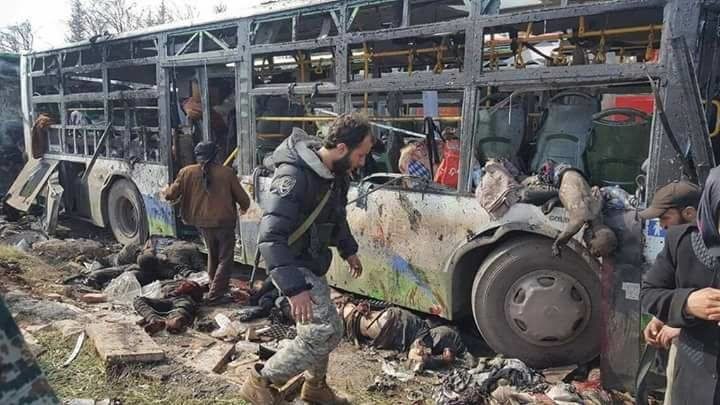 Nhấn để phóng to Still image shows bodies lying near burnt out buses in what is said to be Aleppo's outskirts