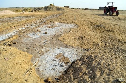 Salt bleaches cracked earth near a farm in Al-Islah, Iraq