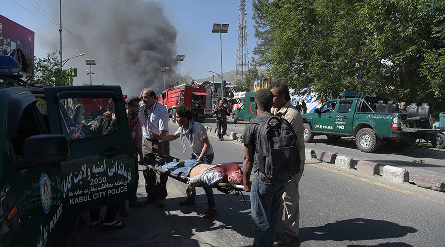 A victim is carried away on a stretcher at the site of a car bomb attack in Kabul
