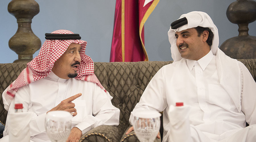 Saudi King Salman (L) chatting with Emir of Qatar Sheikh Tamim bin Hamad al-Thani