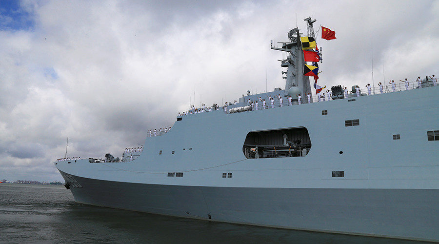 Soldiers of China's People's Liberation Army (PLA) salute from a ship