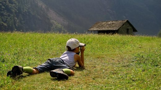 Child looking through binoculars at the nature_1920x1080