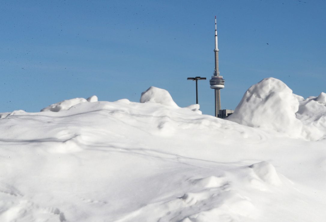Snow piles up in parking lots at the Canadian National Exhibition as Toronto tries to stay warm in the extreme cold.