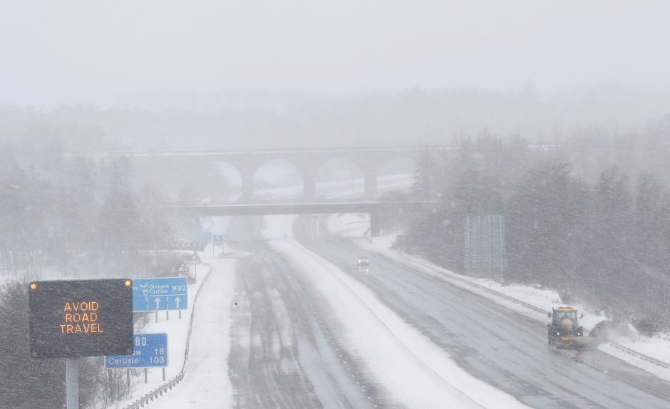 Drivers were being urged to stay off the road Thursday as snowplows cleared the way along the M80 motorway, near Castlecary, Scotland.