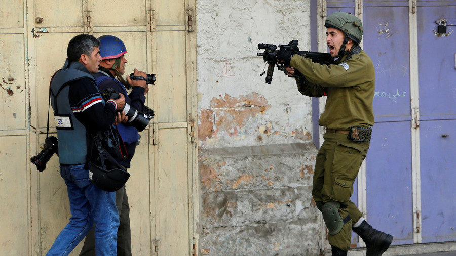 Israel soldier points gun at journalists at Hebron, West Bank Dec 2017