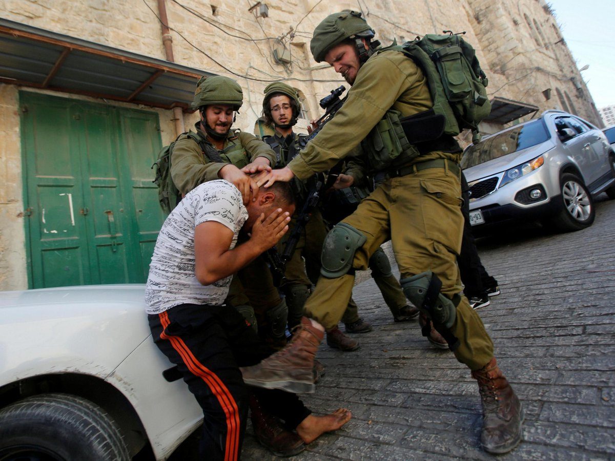 Israel soldiers beating Palestine man