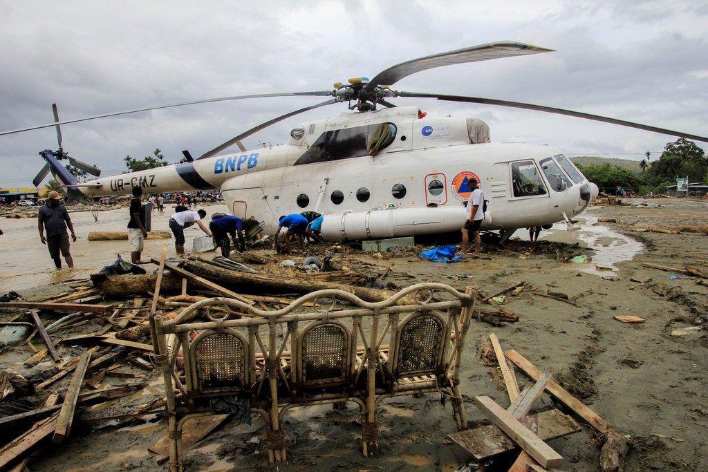 Flash floods in Sentani, Papua, Indonesia, left debris and mud around a helicopter on Sunday.